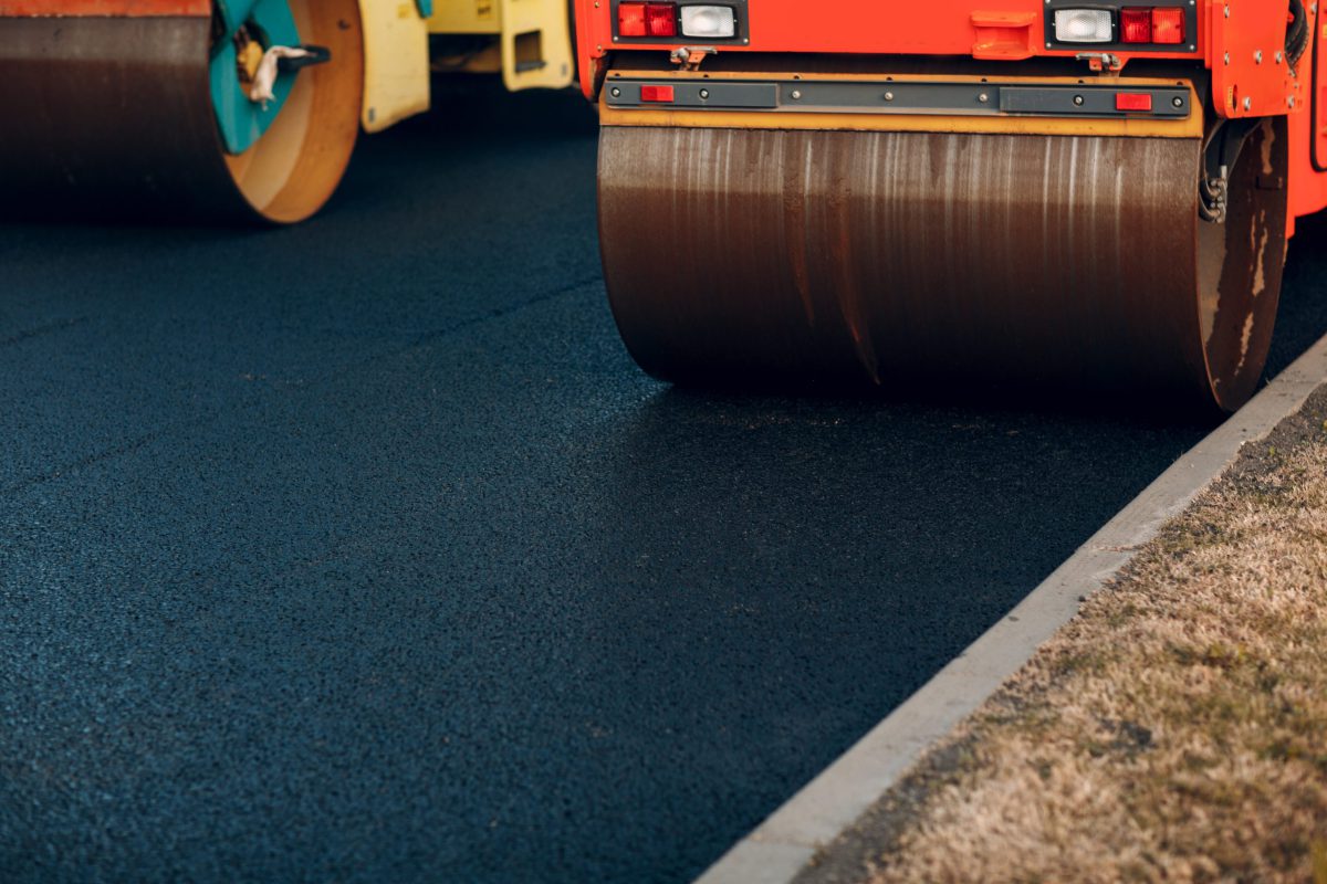 Asphalt paving. Paver road rollers. New road construction.