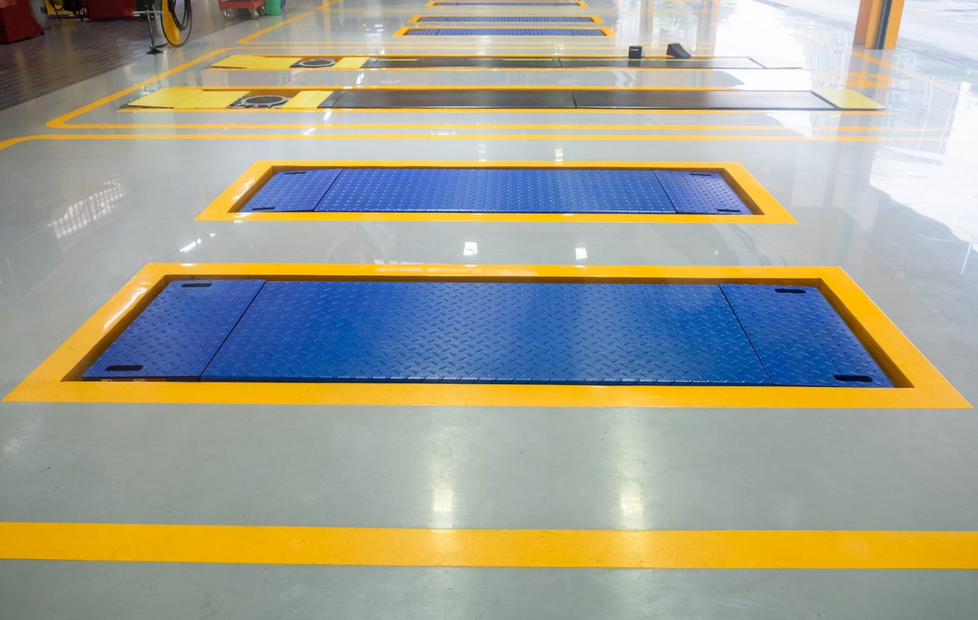 Parking car repair lift in garage blue yellow